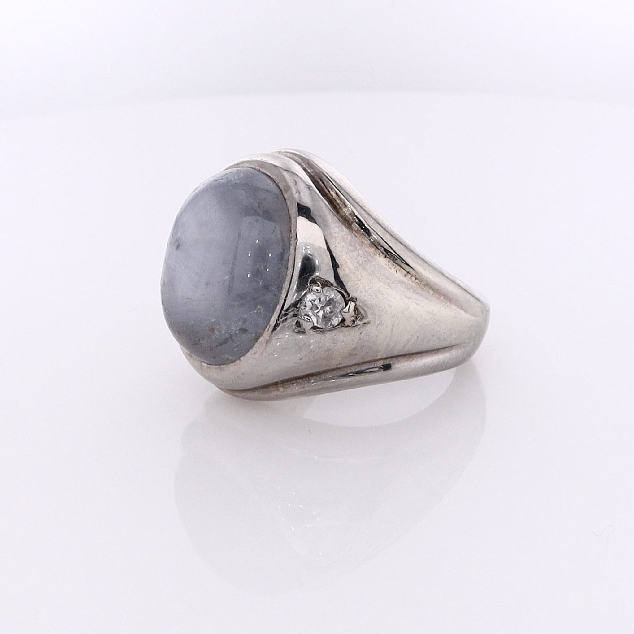 Luxurious 14k White Gold Estate Ring Featuring Oval Cabochon Sapphire and Sparkling Diamonds