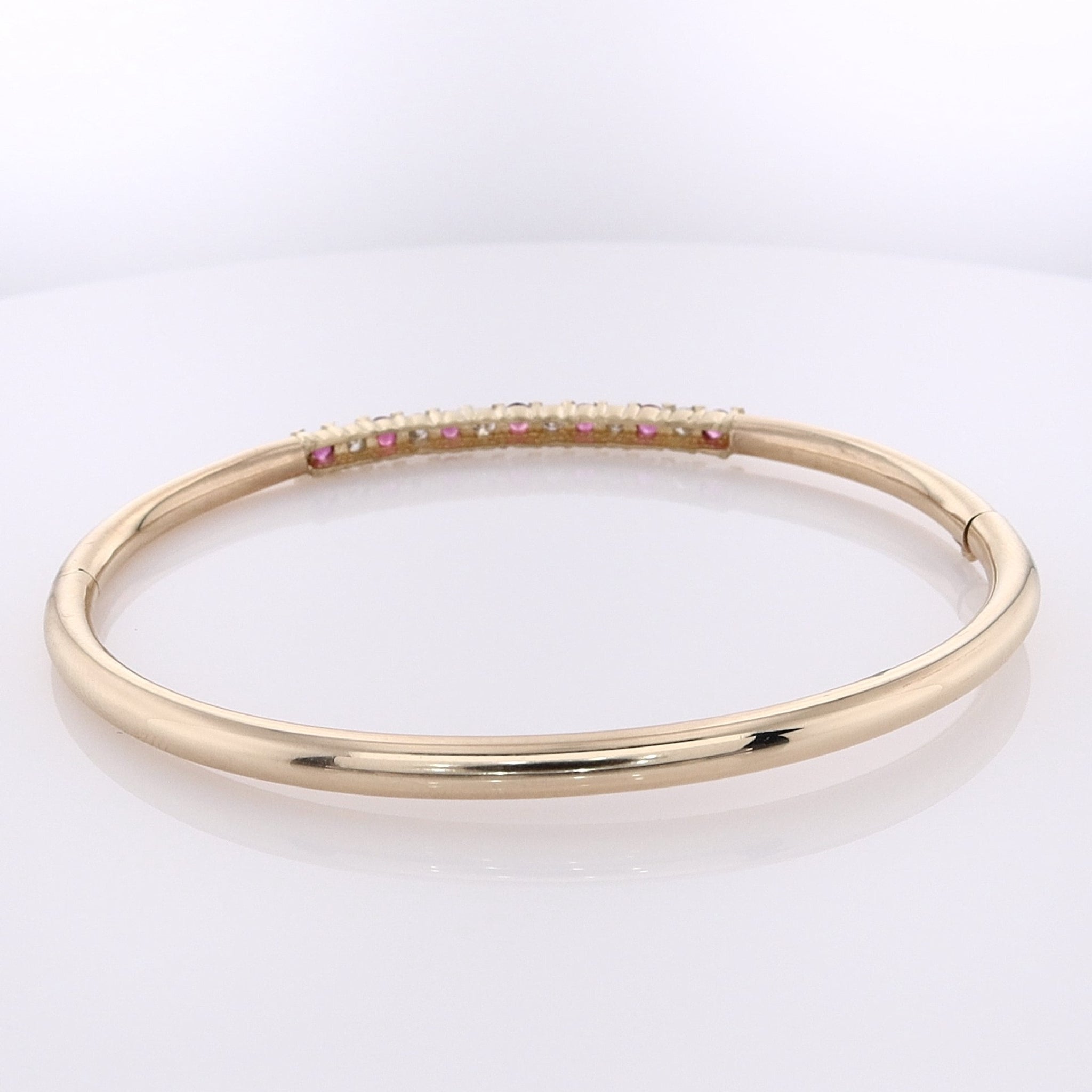 Luxurious Estate 14 Karat Yellow Gold Bangle Bracelet with Alternating Round Rubies and Round Brilliant Cut Diamonds