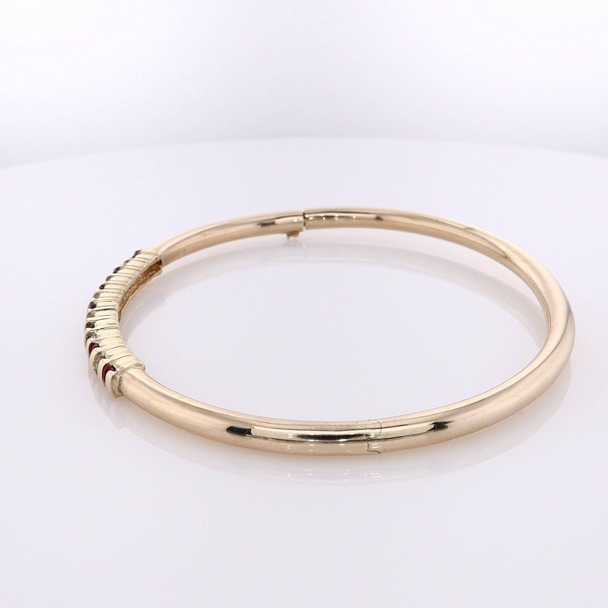 Luxurious Estate 14 Karat Yellow Gold Bangle Bracelet with Alternating Round Rubies and Round Brilliant Cut Diamonds